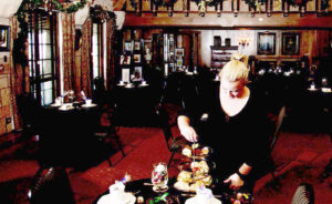A food service associate sets up a table for one of the Holiday Teas. Photo by Paul DiSalvo