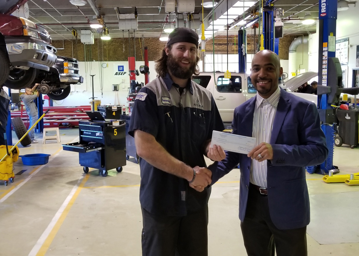 Dominick Burch, of Arapahoe Community College, receives a scholarship from George Billings, program director for the Clear Air Foundation.