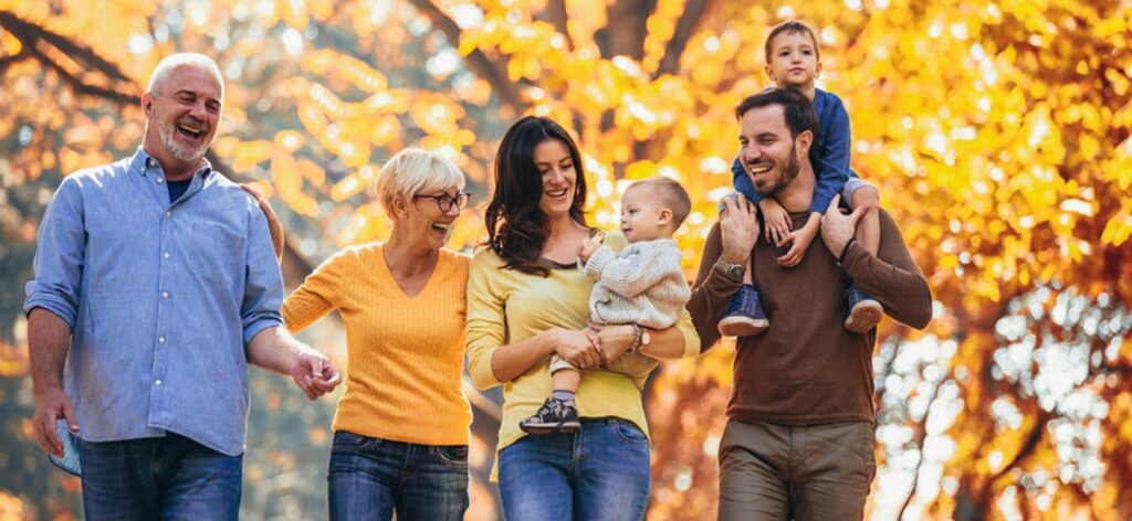 Multi-generational family walking through the woods.